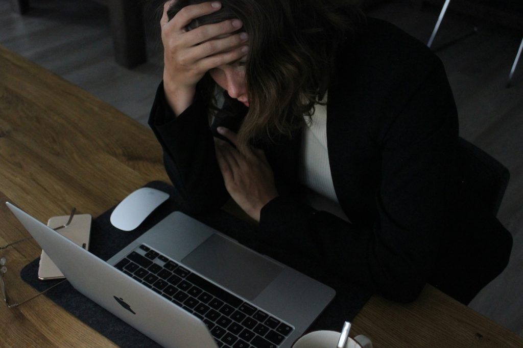 Vacation rental host at a laptop, uneasy about relying only on Airbnb