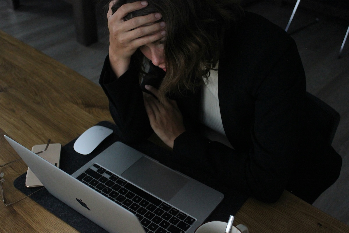 Vacation rental host at a laptop, uneasy about relying only on Airbnb